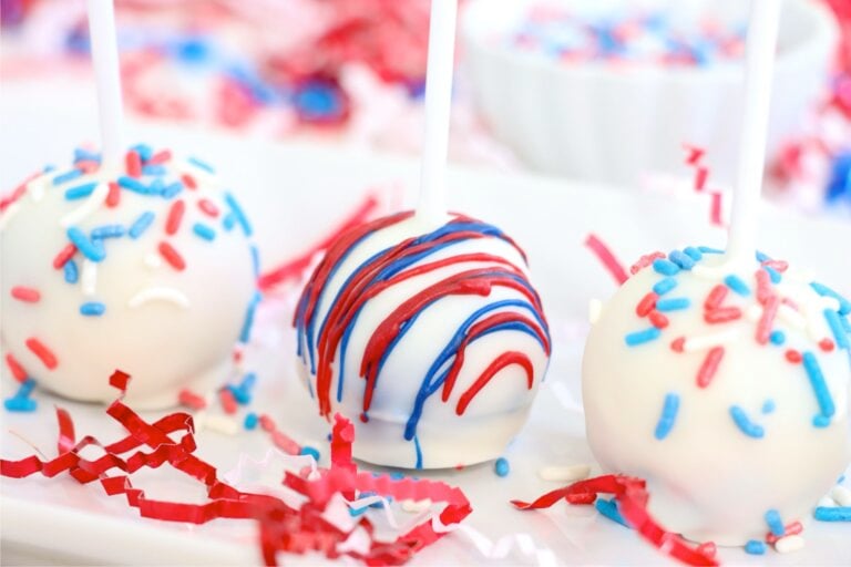 Decorated 4th of July cake pops lined up on a tray.