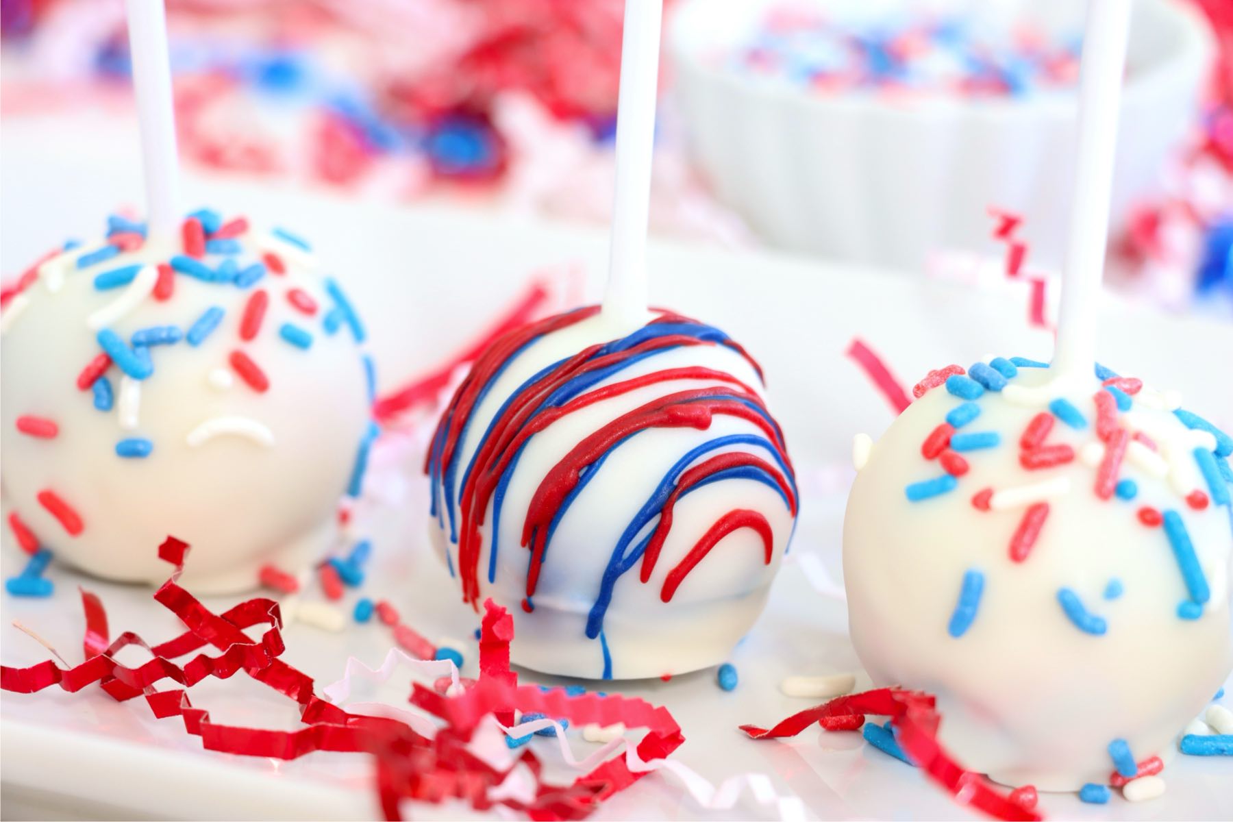 Decorated 4th of July cake pops lined up on a tray.