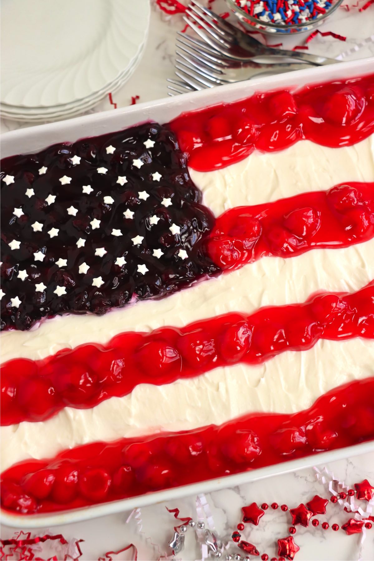 American flag cheesecake topped with star sprinkles in the blueberry section.