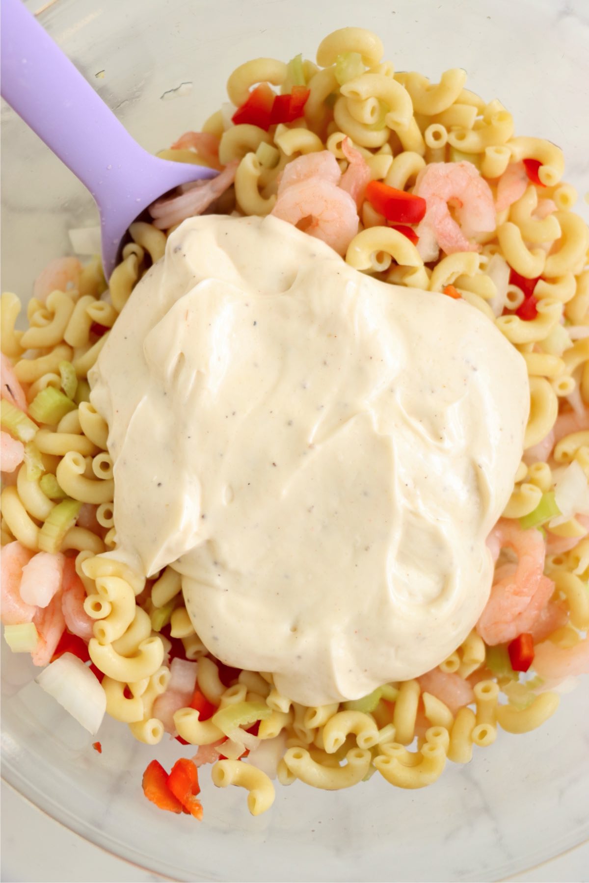 Creamy dressing poured over the pasta, shrimp, and vegetables.