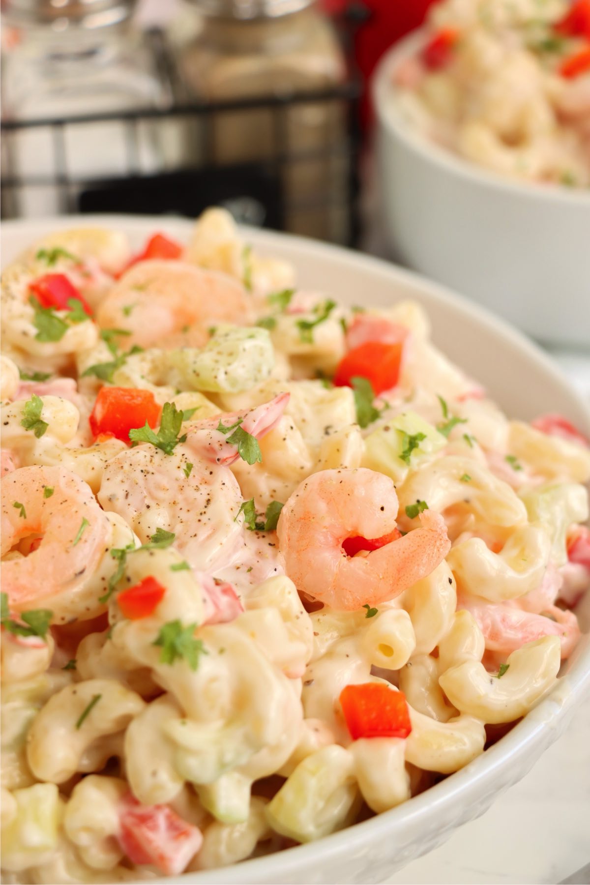 Close-up of creamy shrimp pasta salad with peppers and celery.