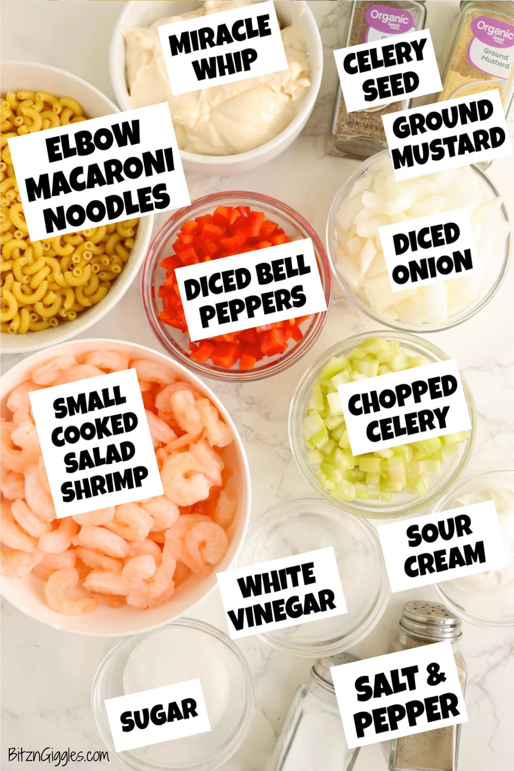 Overhead view of shrimp pasta salad ingredients in bowls, including pasta, shrimp, celery, peppers, onions, and spices.