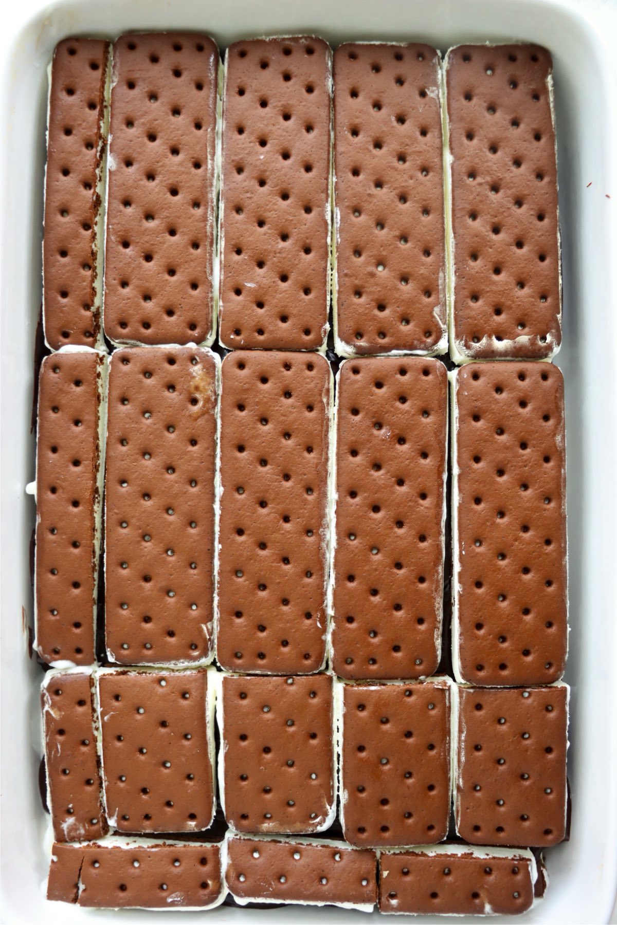 A layer of ice cream sandwiches placed on top of the chocolate sauce.