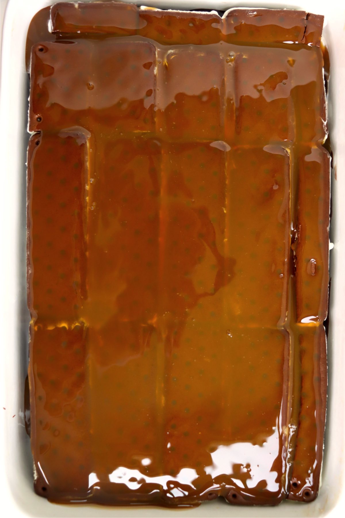 Caramel sauce covering the second layer of ice cream sandwiches.