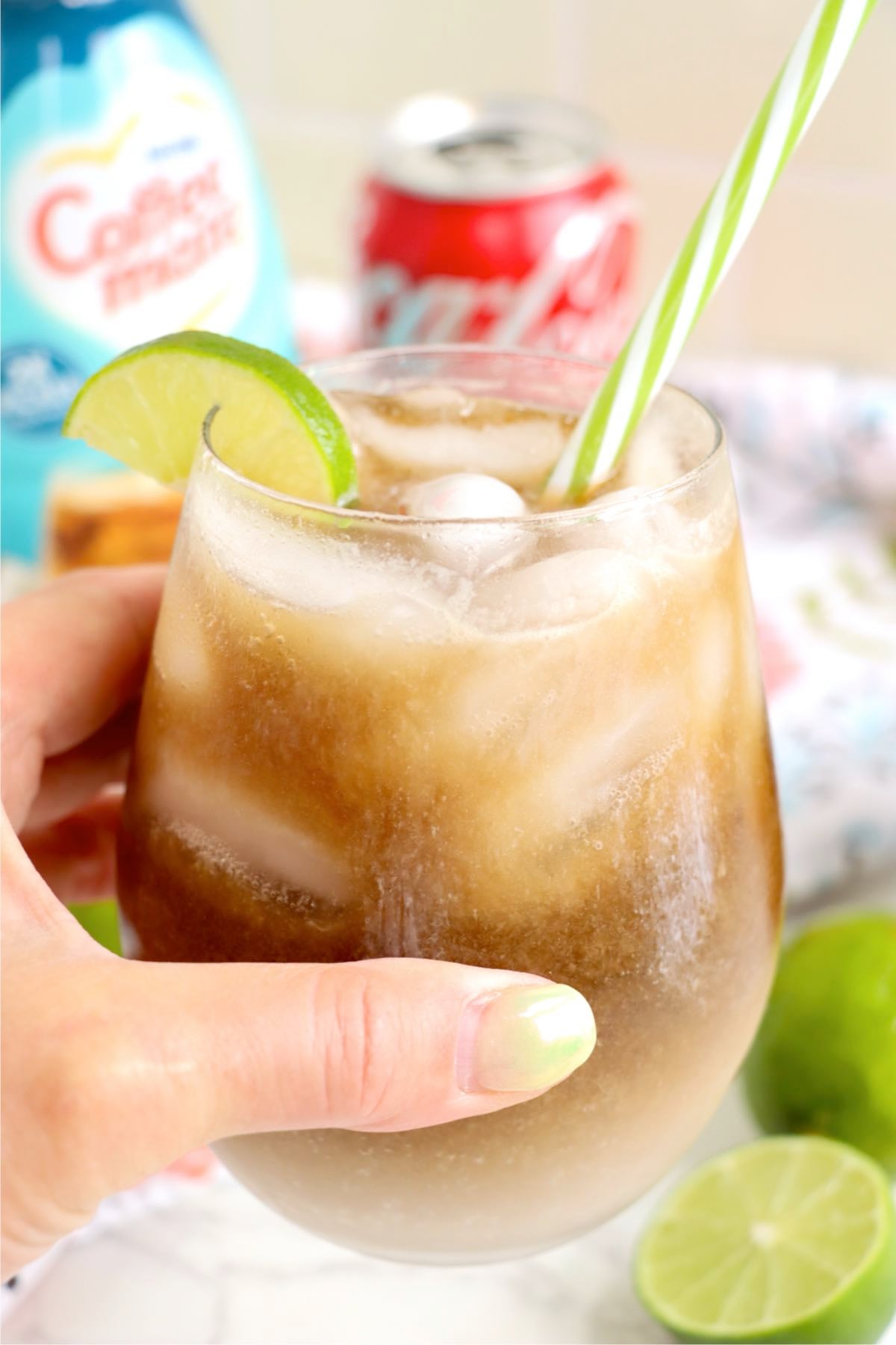 Hand holding a Dirty Coke drink.