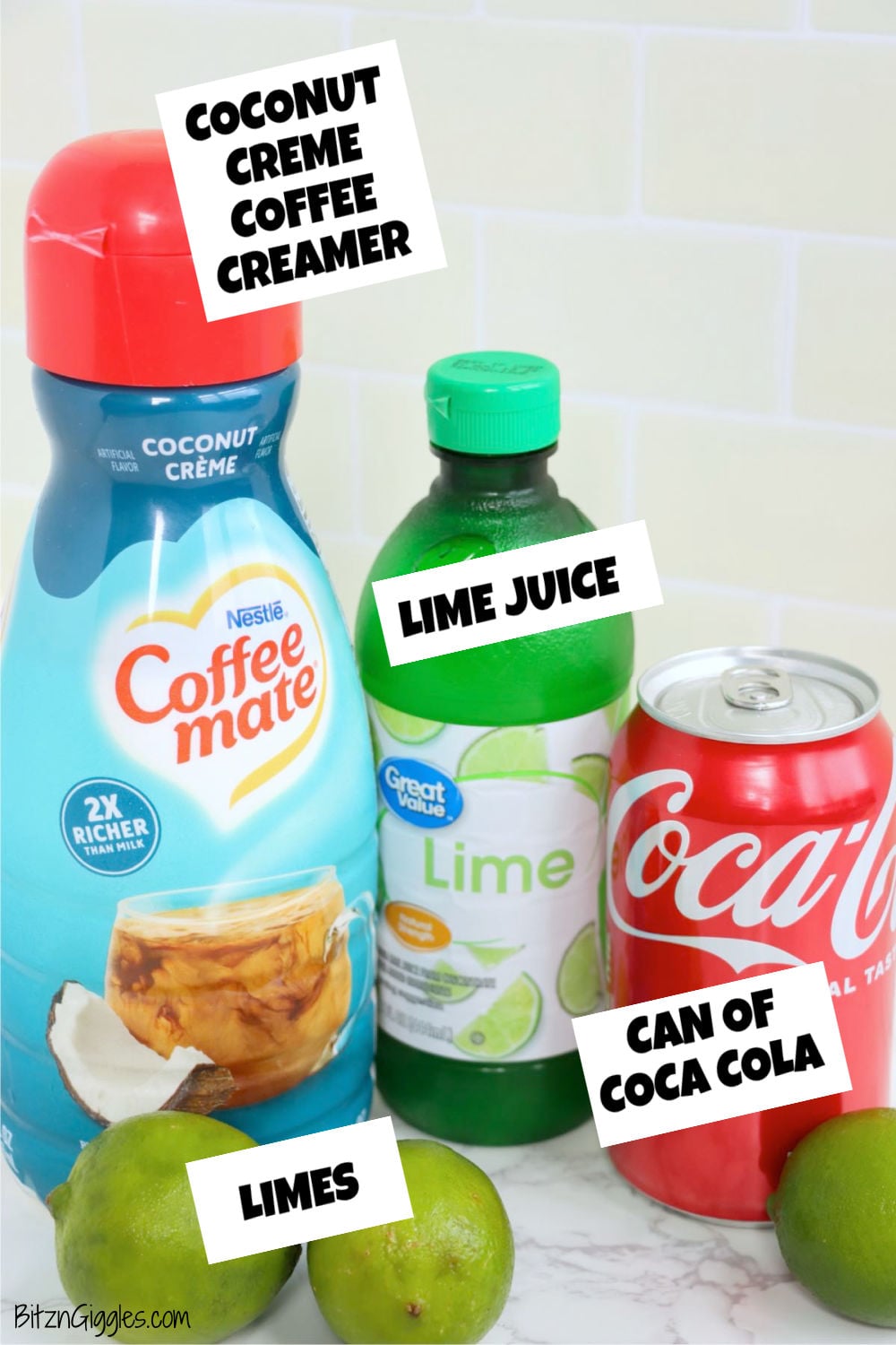 Ingredients on a counter including coconut crème coffee creamer, lime juice, fresh limes, and a can of cola.