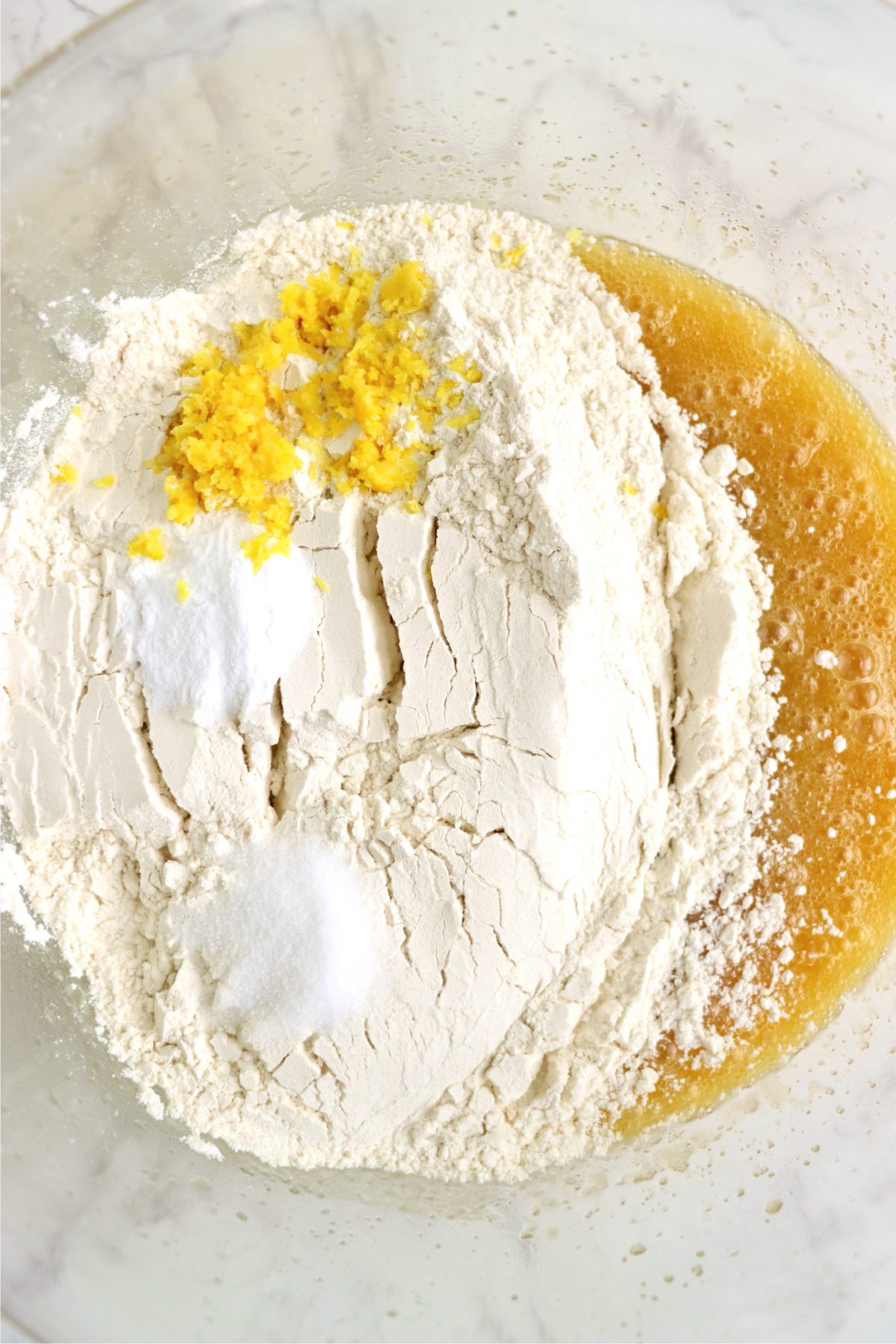 Flour, lemon zest, baking soda, and salt added into the wet mixture.