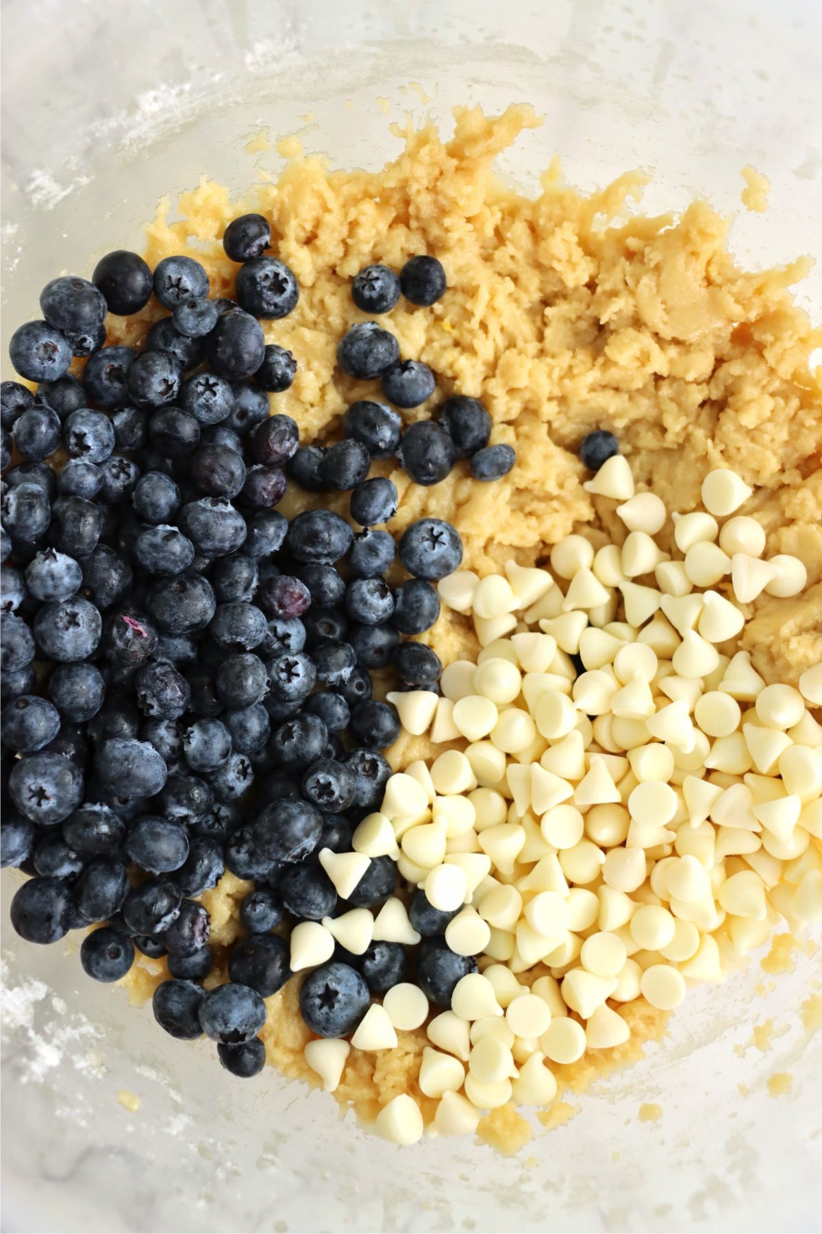 Fresh blueberries and white chocolate chips added on top of the cookie dough.
