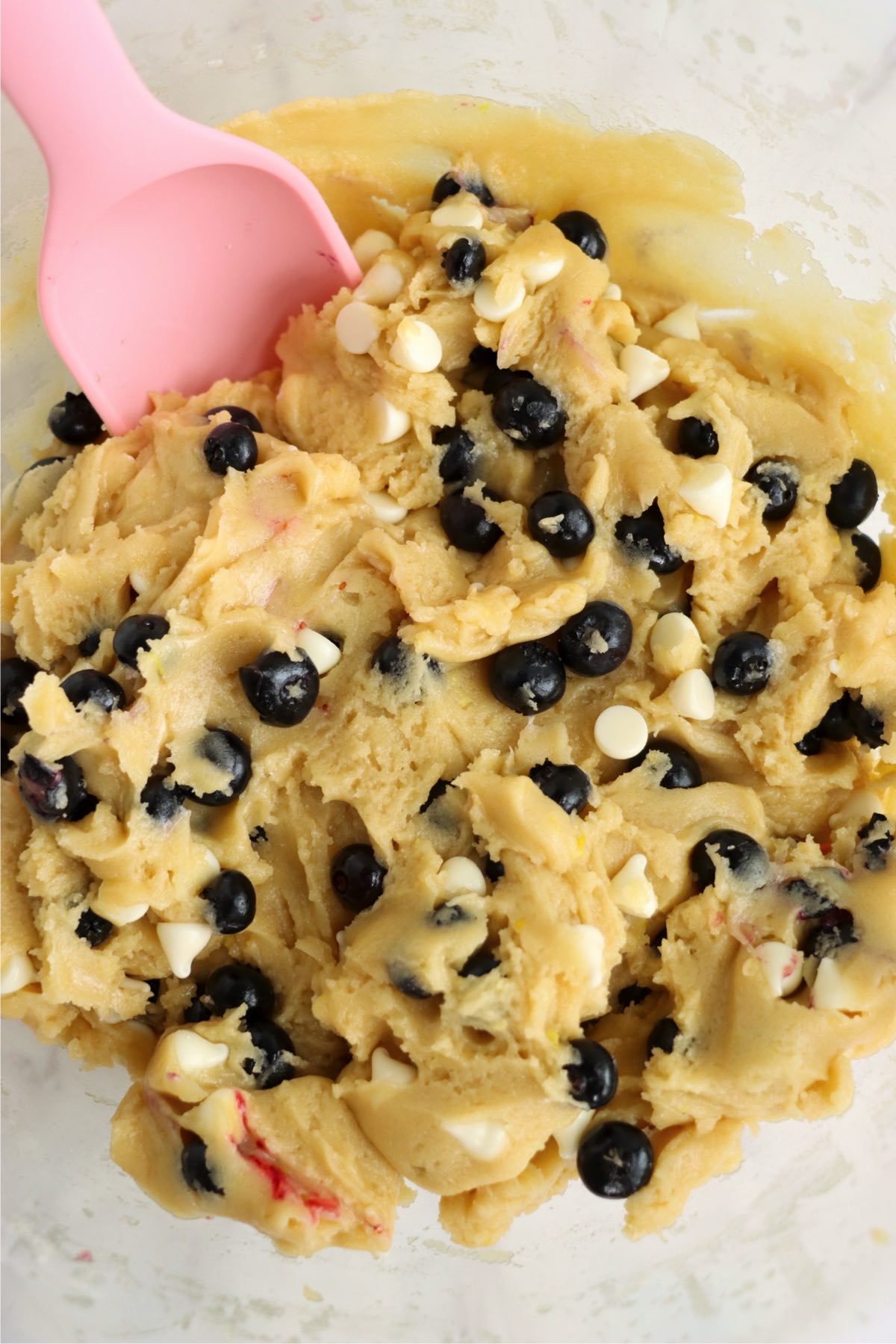 Cookie dough mixed together with blueberries and white chocolate chips throughout.