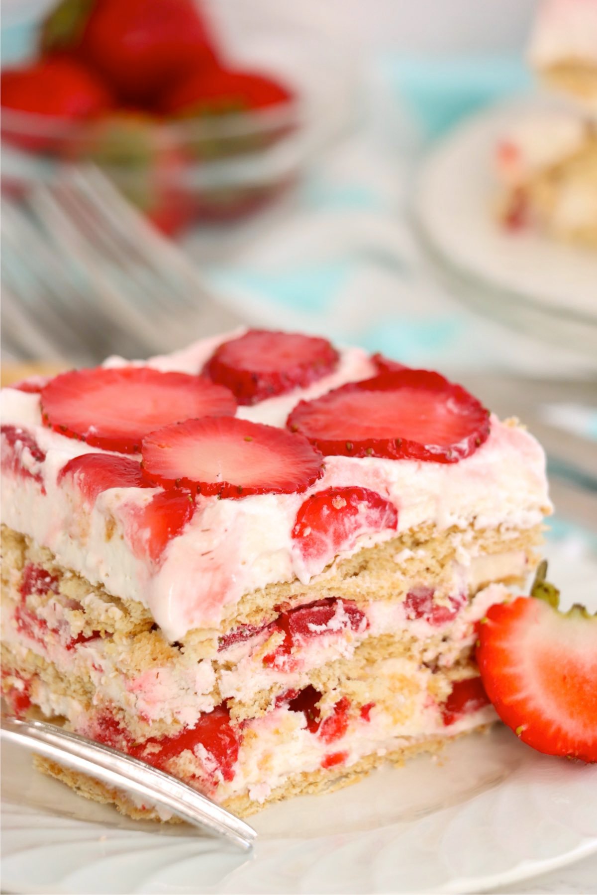 Single serving of strawberry icebox cake on a plate with a fork.