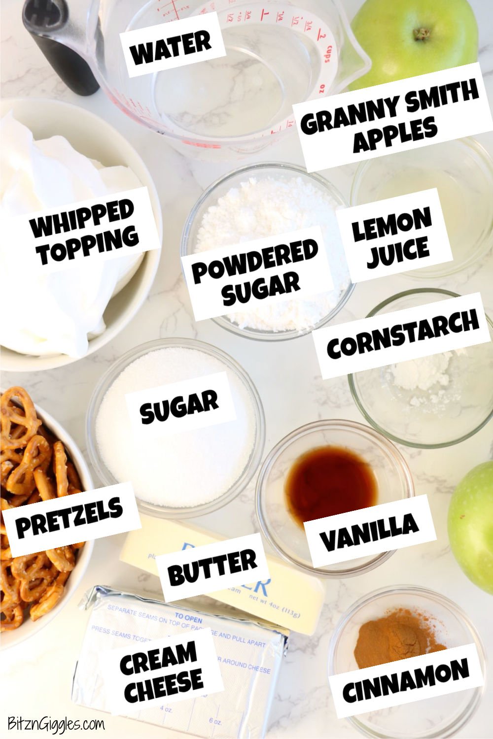 Overhead view of ingredients for apple cinnamon pretzel salad, including Granny Smith apples, cream cheese, pretzels, cinnamon, and sugar.
