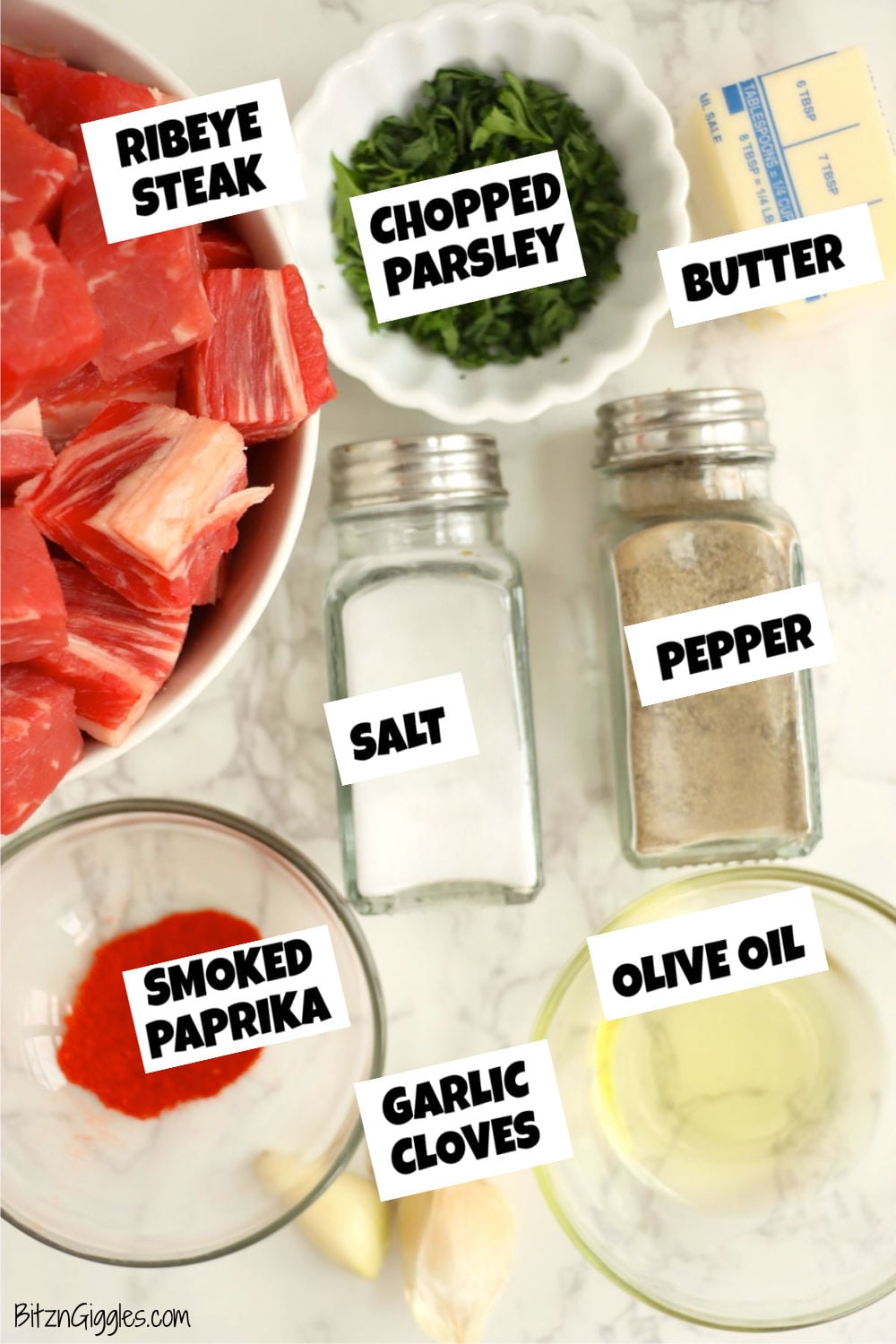 Ingredients for air fryer garlic butter steak bites, including ribeye, butter, garlic, olive oil, and seasonings.