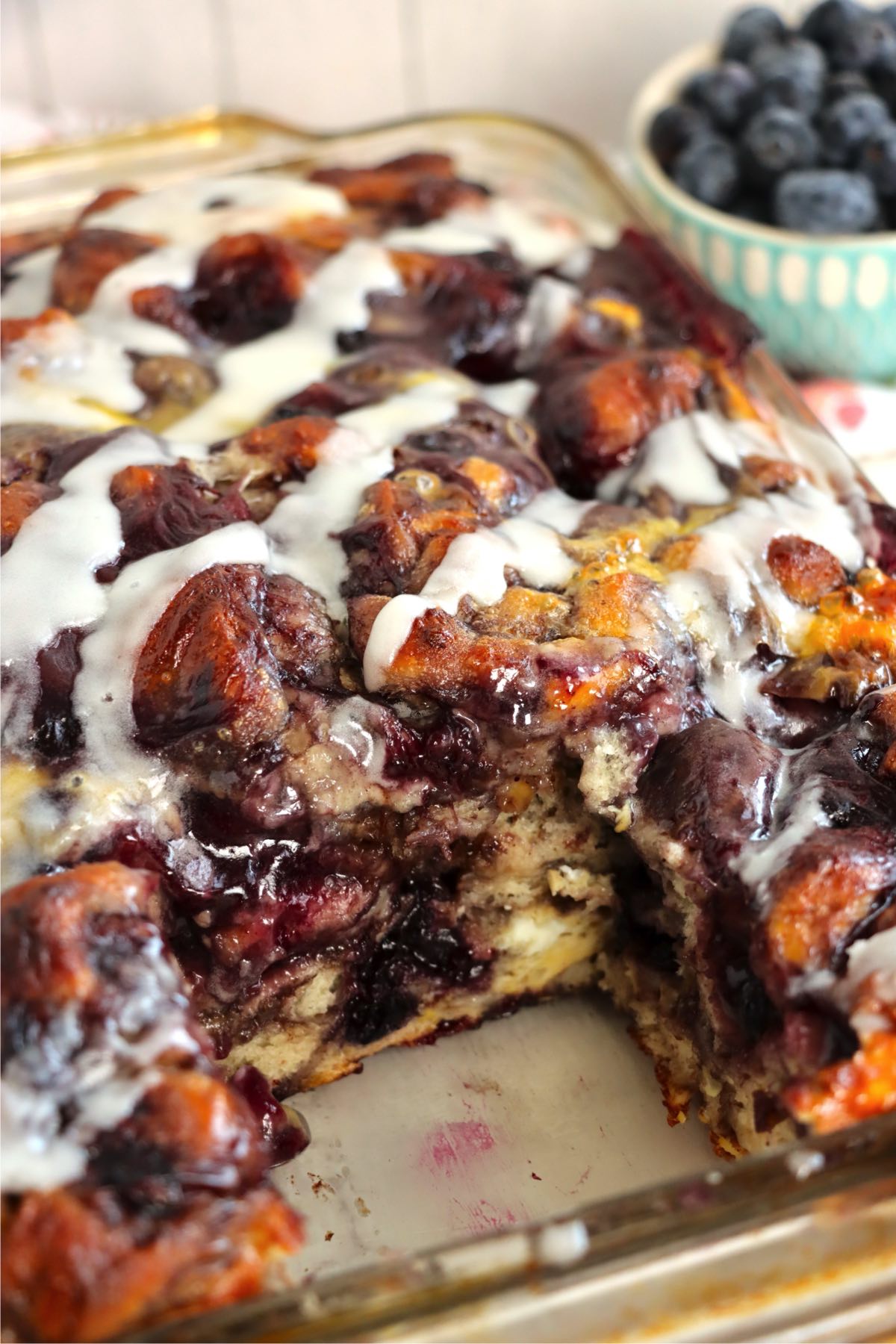 A sliced section showing the soft, blueberry-filled interior of the baked casserole.