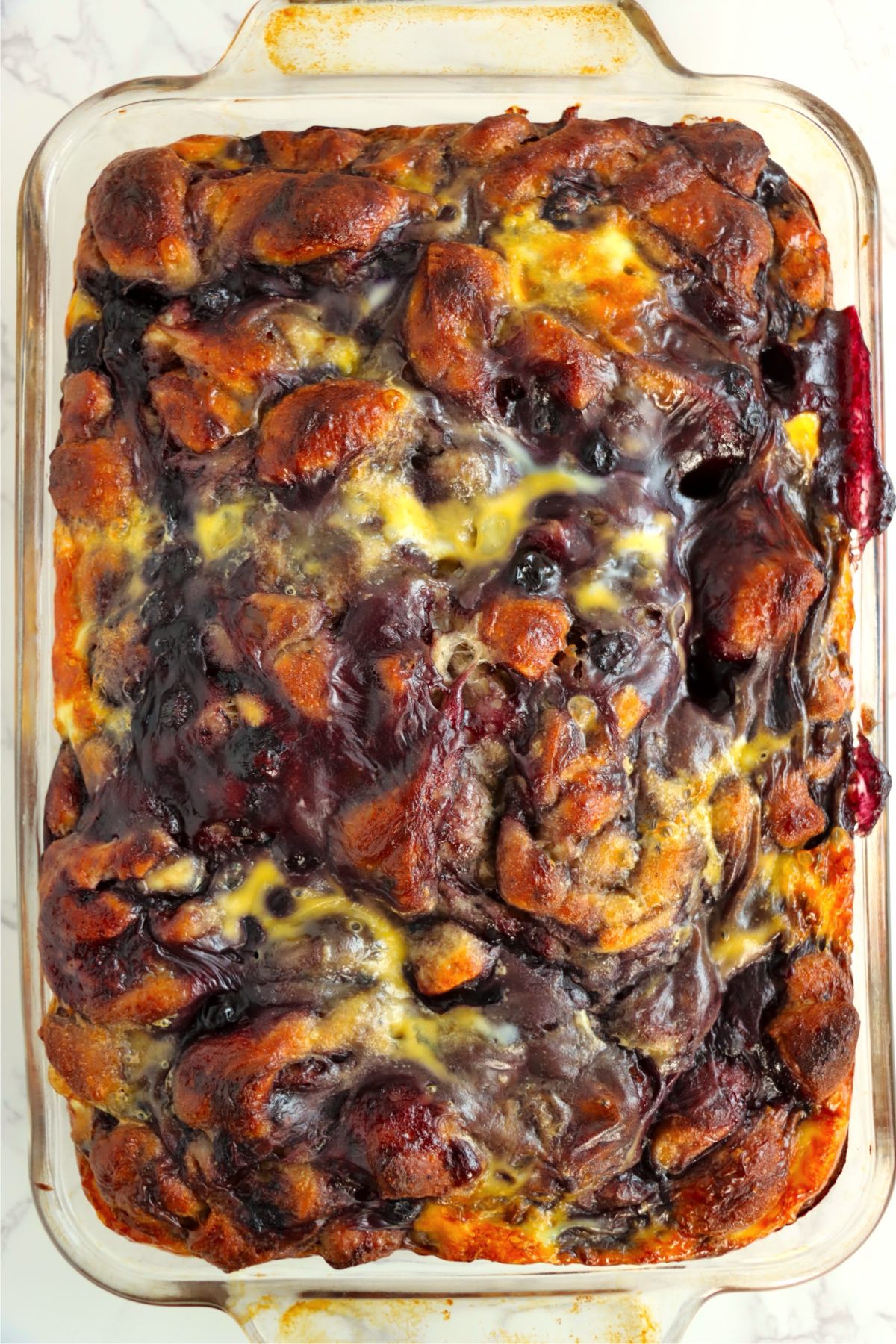 Freshly baked casserole with golden, caramelized cinnamon roll pieces.