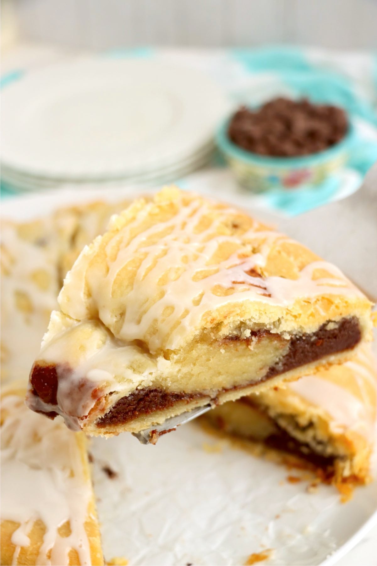 A slice of chocolate-filled kringle lifted from the pan to show the layers inside.