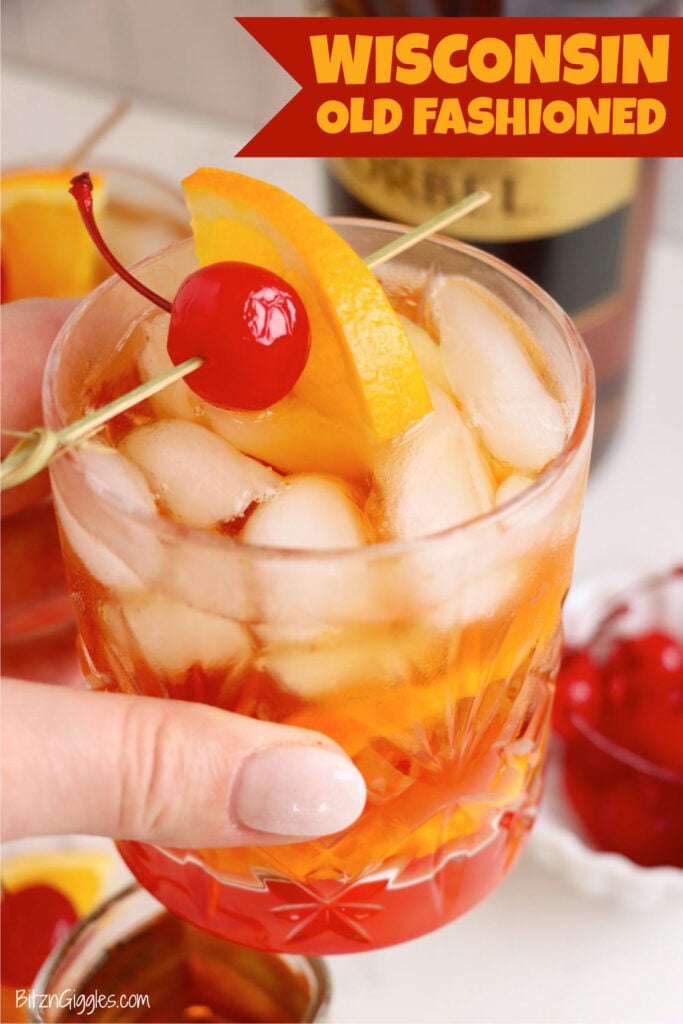A Wisconsin Old Fashioned cocktail styled with cherries, orange slices, brandy, and bitters for a classic presentation.