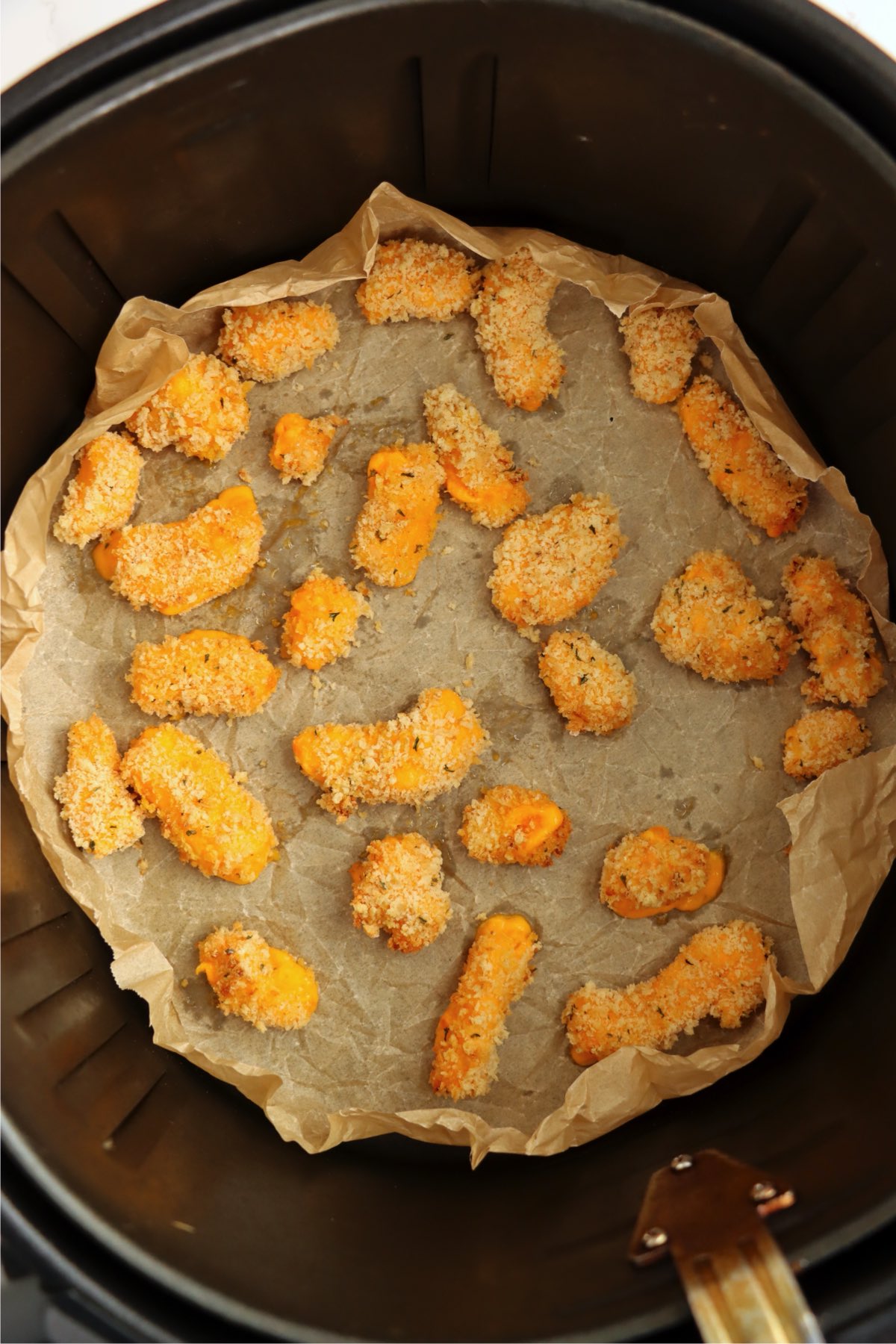 Golden air fryer cheese curds after cooking.