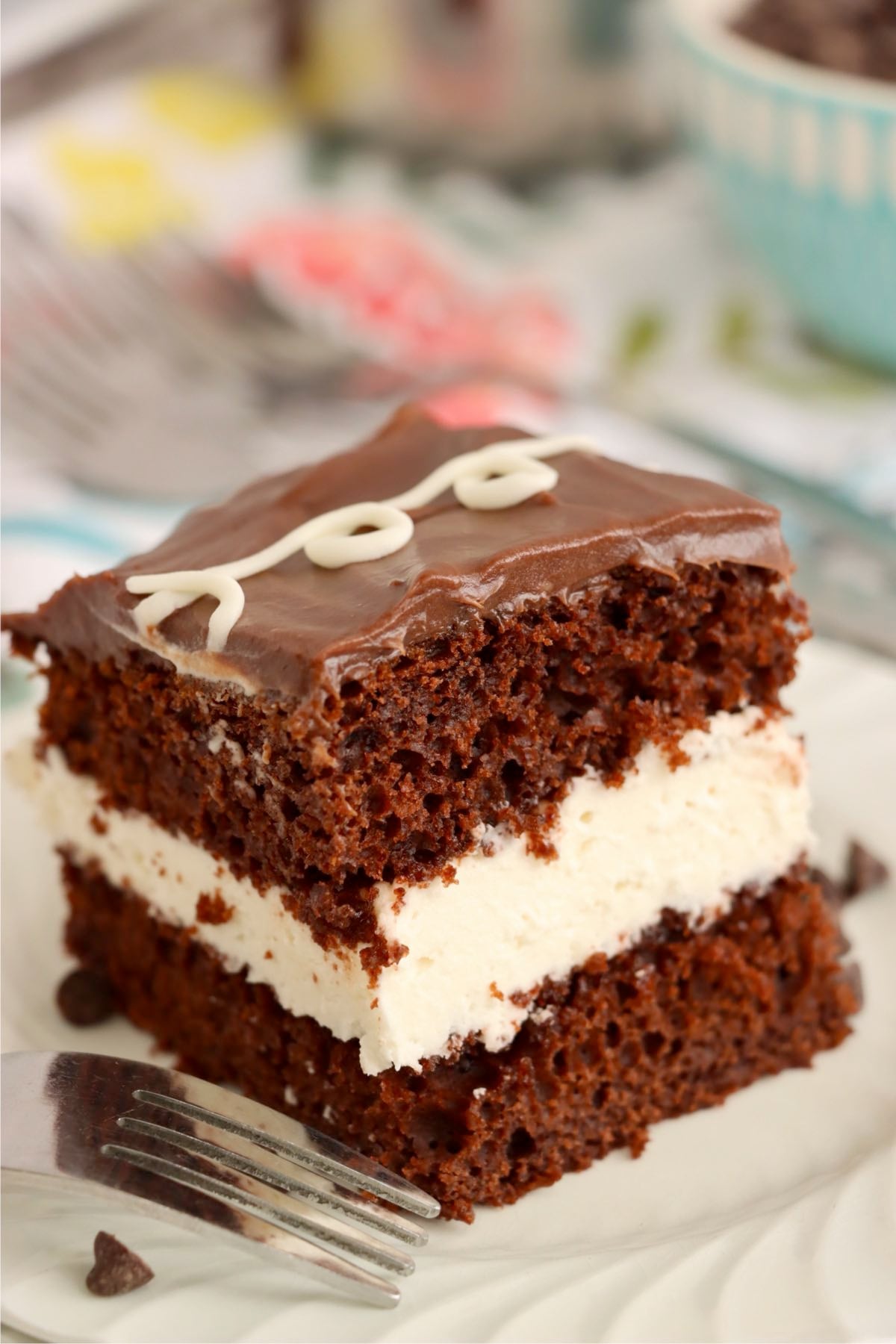 Chocolate cake slice lifted with a spatula showing marshmallow cream center.