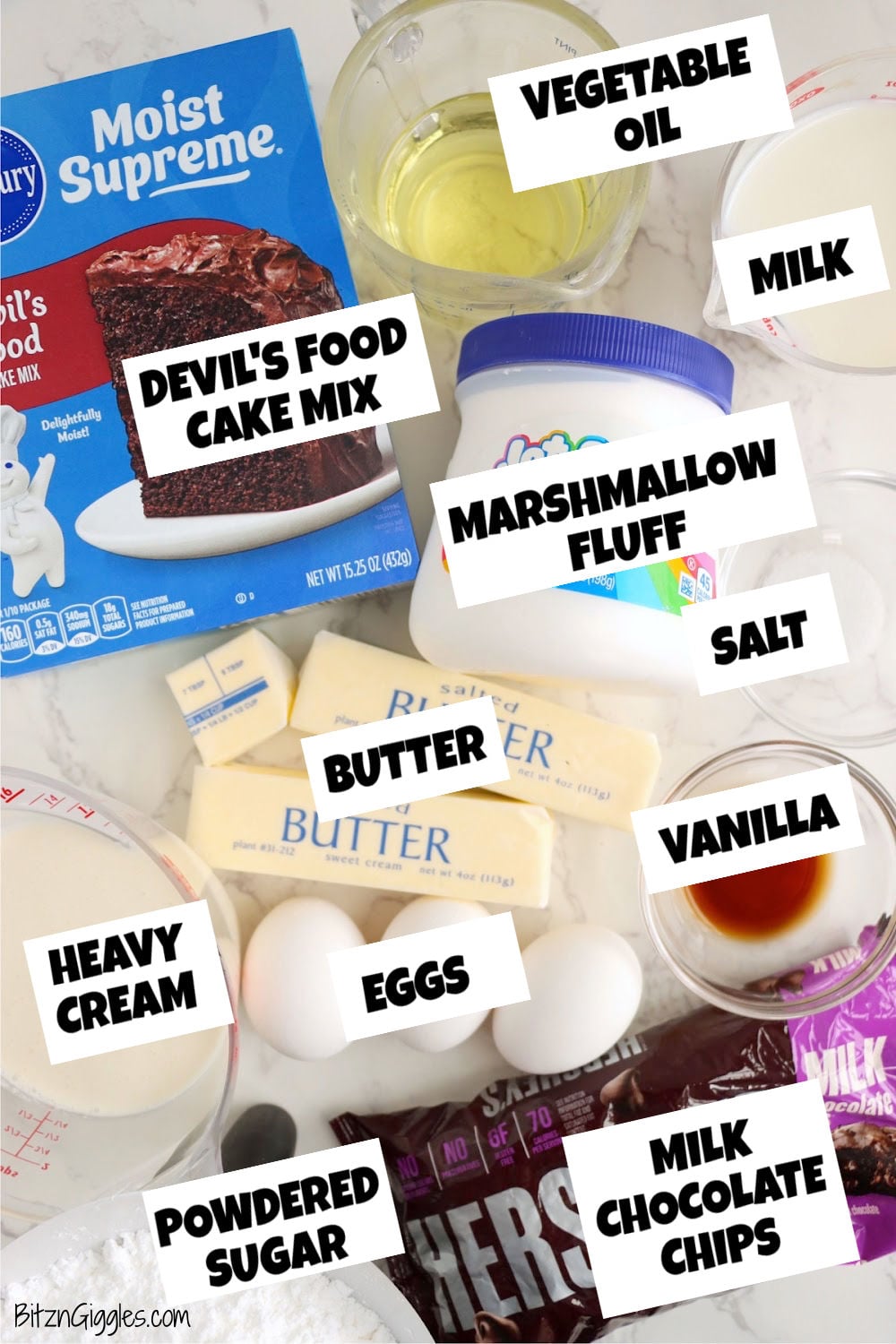 Ingredients on a white surface including cake mix, eggs, butter, marshmallow fluff, and chocolate chips.