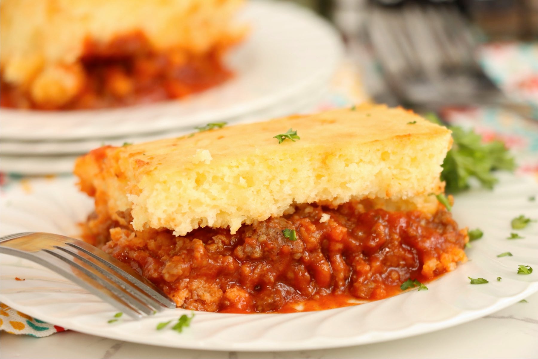 A slice of Sloppy Joe Bake showing the saucy meat layer and golden topping.