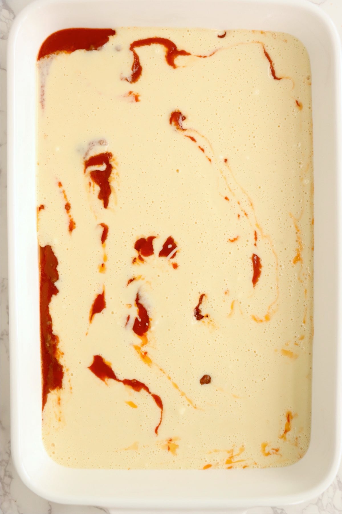 Sloppy Joe Bake before baking with batter covering the meat layer.