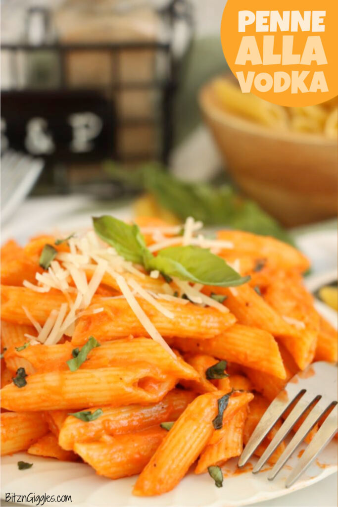 Penne alla vodka served with parmesan and fresh basil leaves.