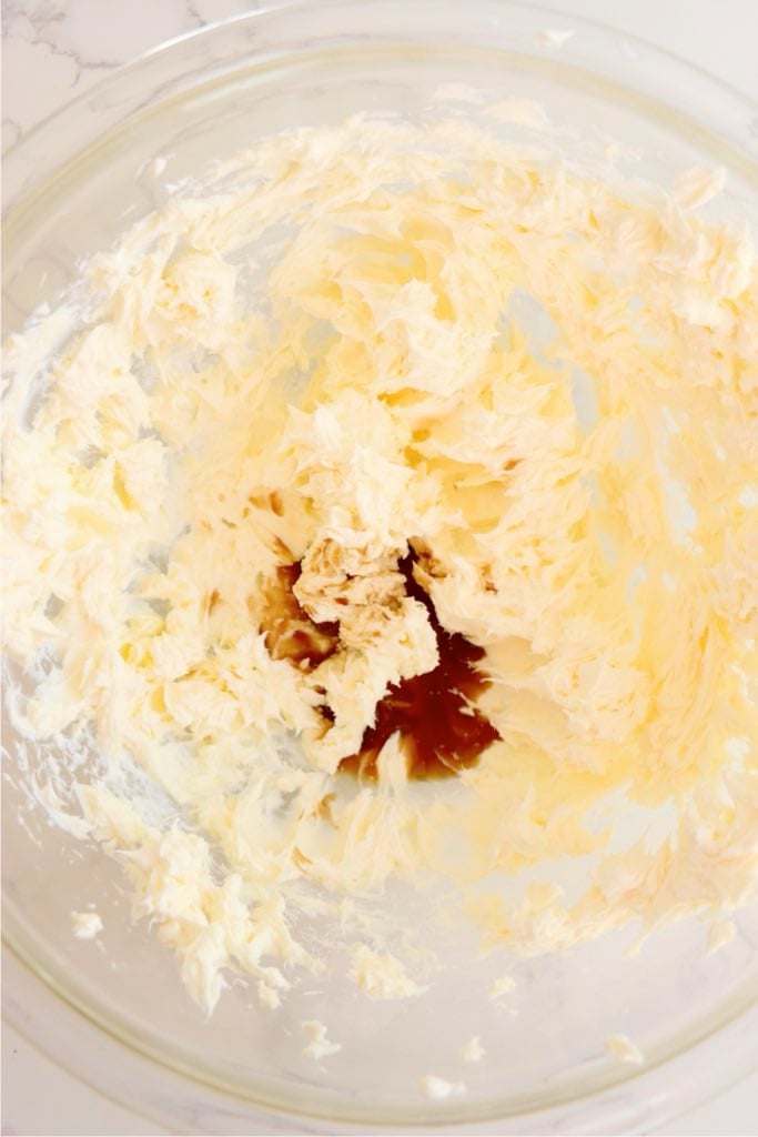 Adding vanilla extract to cream cheese frosting.
