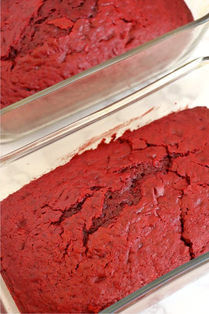 Close-up view of a baked red velvet loaf cake with a cracked top.