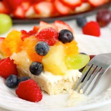 Fresh fruit tart with a bite taken out.