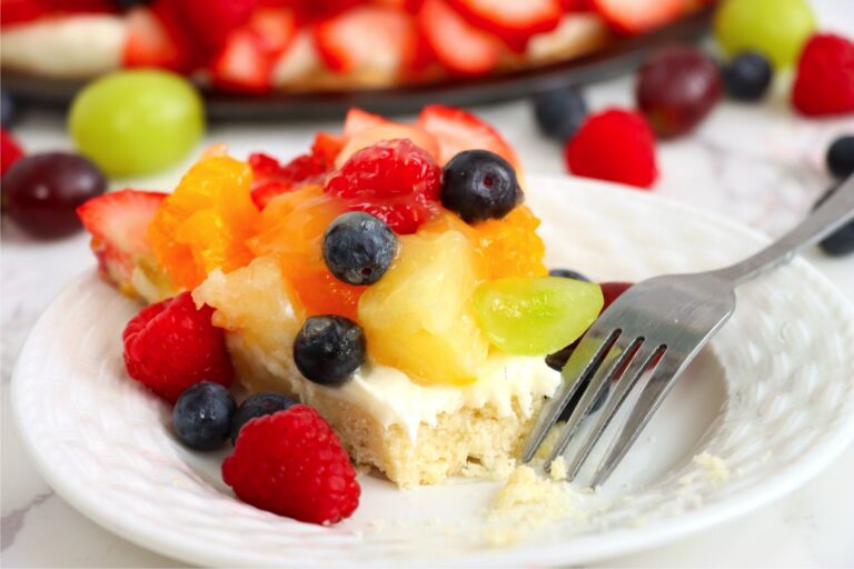 Fresh fruit tart with a bite taken out.