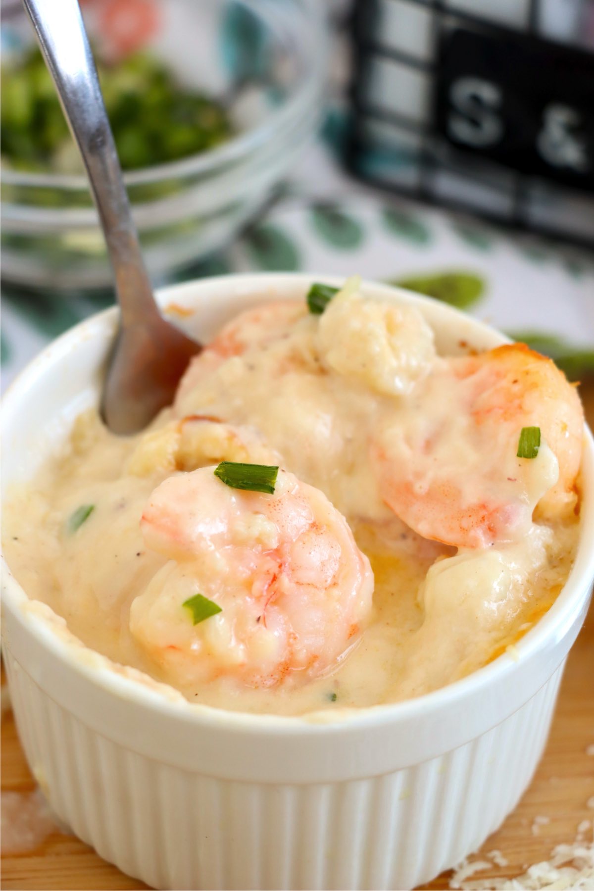 Shrimp and scallops in a creamy cheese sauce in a ramekin.