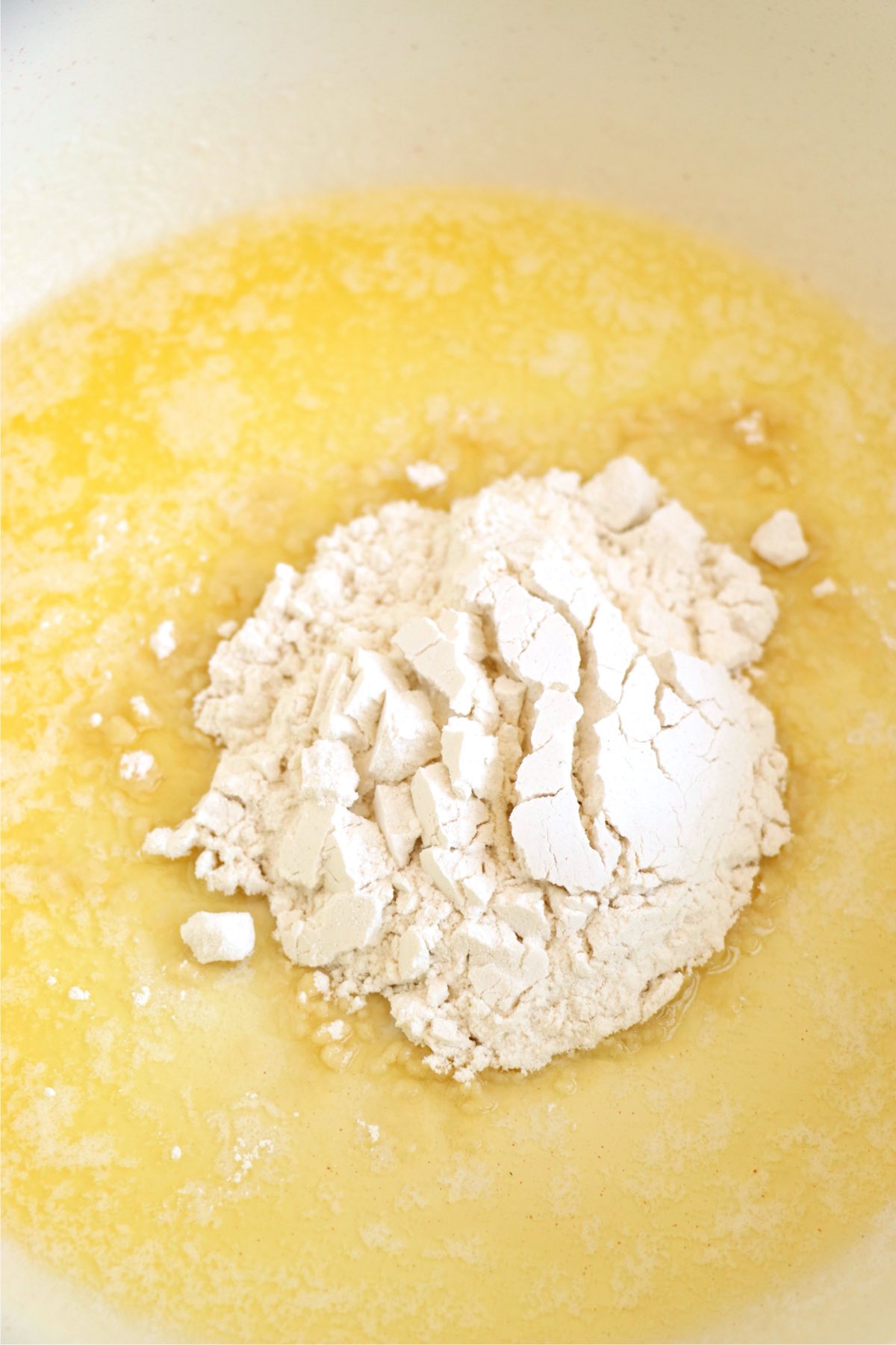 Butter and flour cooking together in a saucepan to make a roux for a creamy seafood sauce.