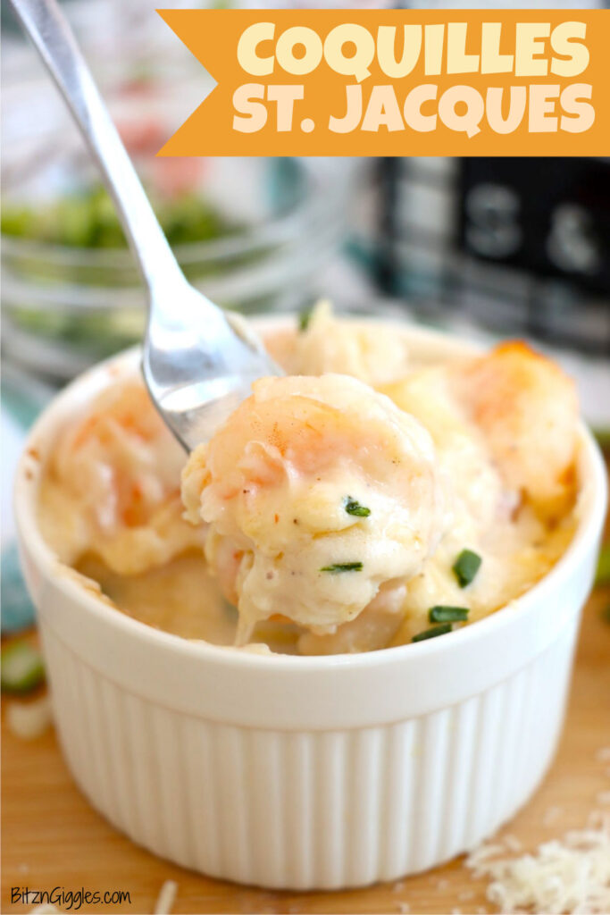 Baked Coquilles St. Jacques in a white ramekin with creamy sauce and shrimp.