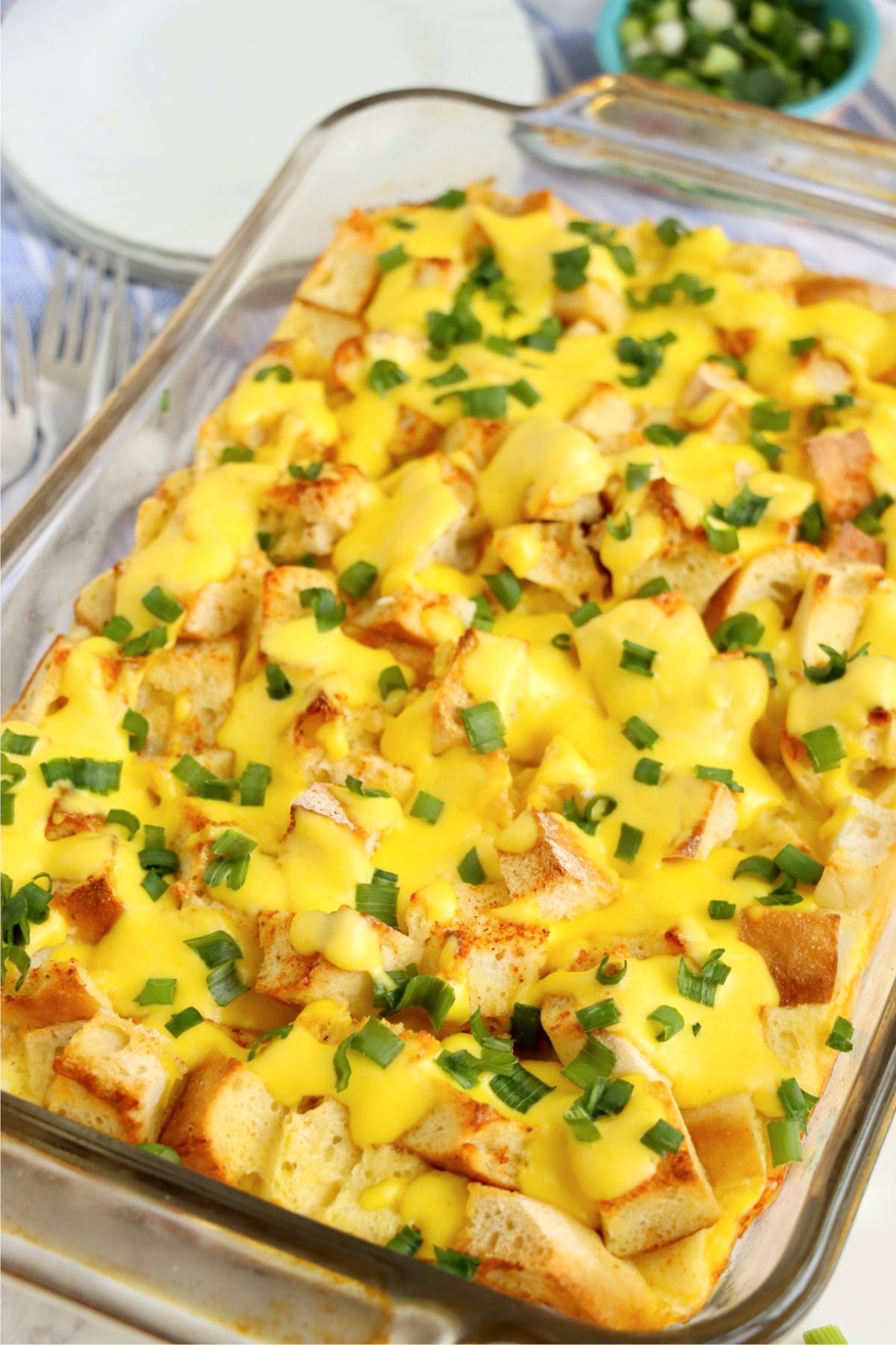 Baked eggs Benedict casserole in a glass baking dish ready to serve.