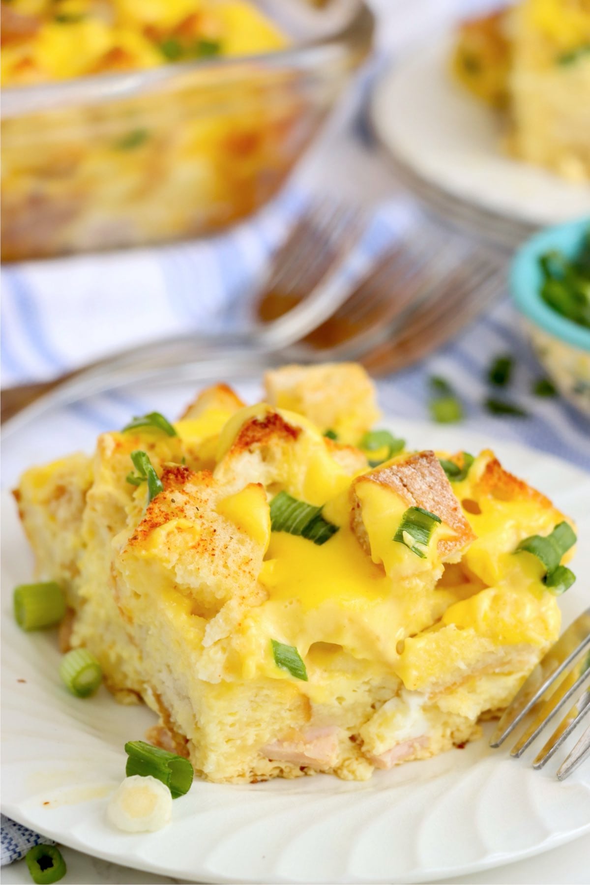 Freshly baked eggs Benedict casserole in a glass baking dish ready to serve.
