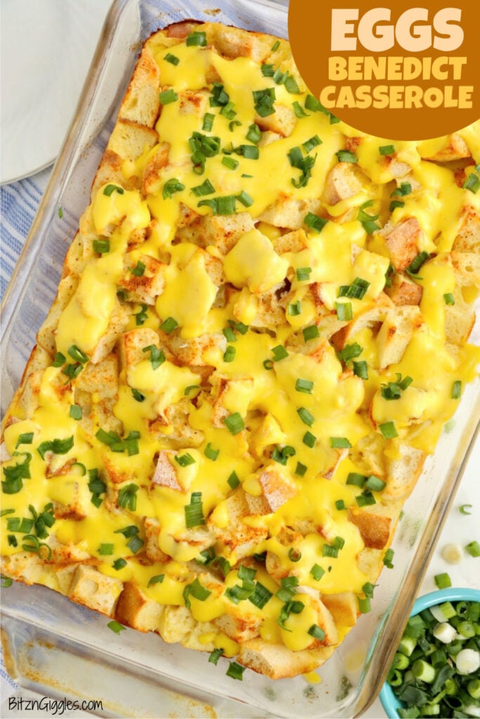 Baked eggs Benedict casserole topped with hollandaise and green onions.