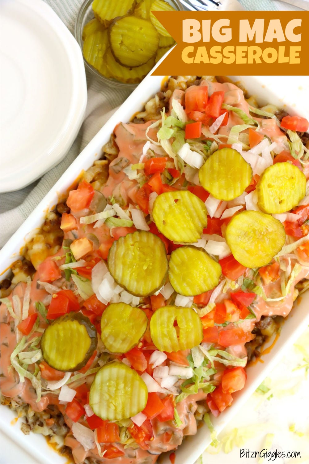 Big Mac casserole topped with fresh ingredients and creamy sauce.