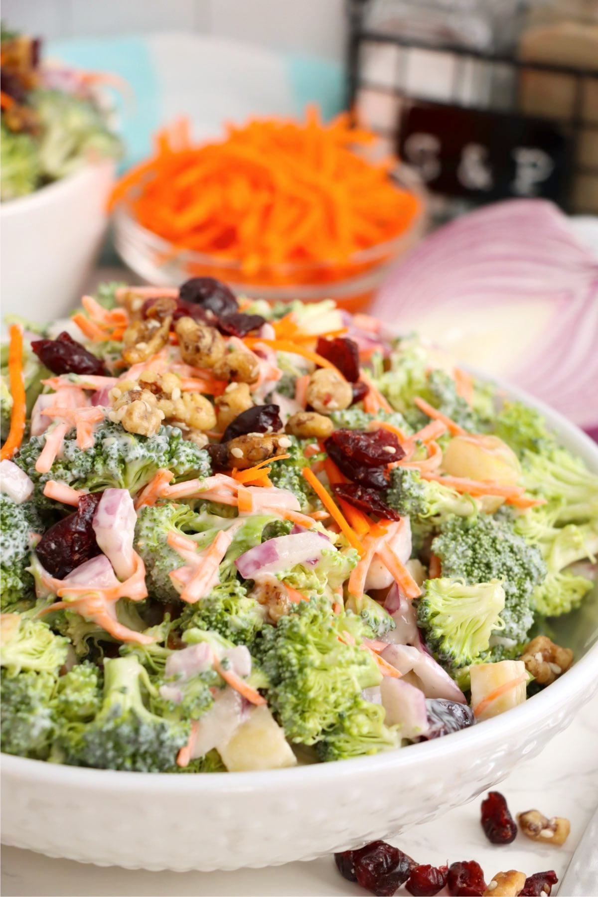 Broccoli crunch salad mixed with creamy dressing, cranberries, walnuts, and fresh vegetables.