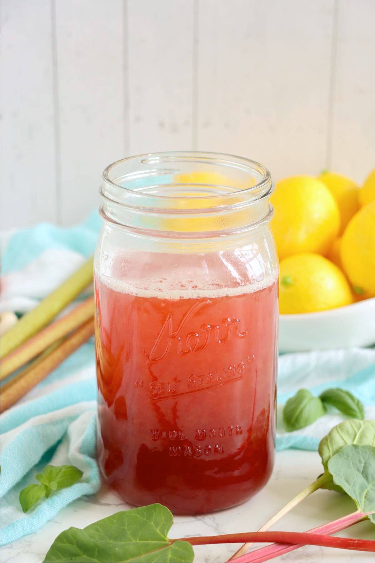 Fresh rhubarb cordial syrup in a mason jar.