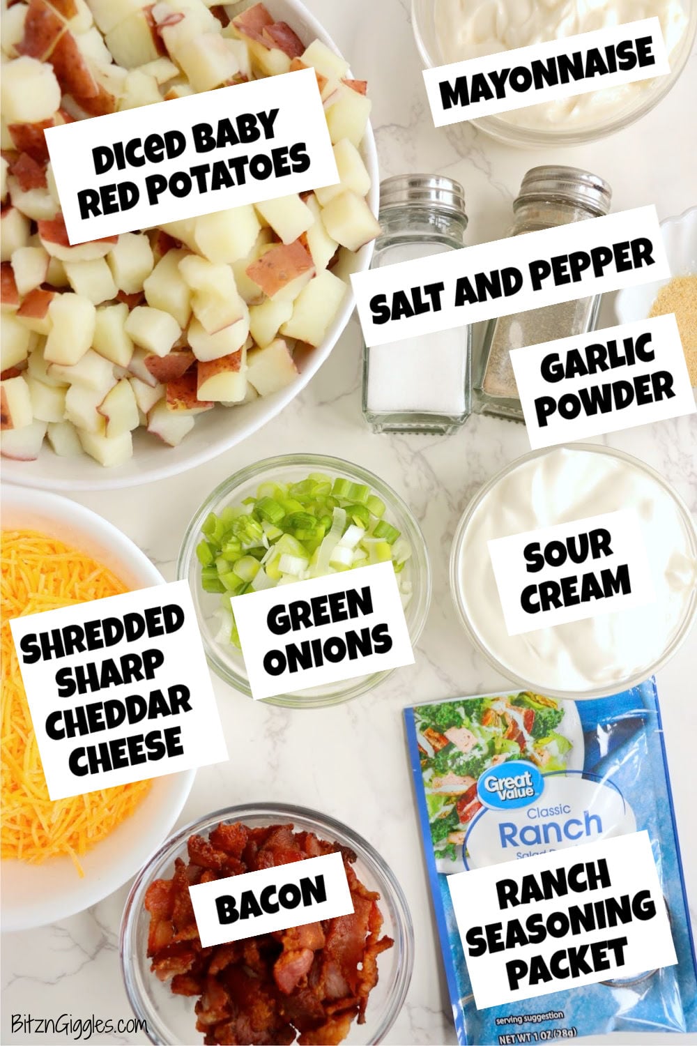 Bowls of diced red potatoes, mayonnaise, sour cream, cheddar cheese, bacon, green onions and ranch seasoning arranged on a countertop.