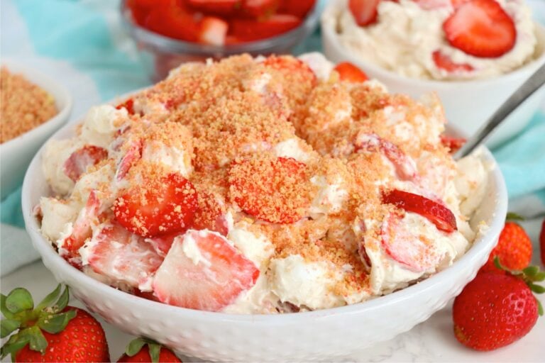 Strawberry Cheesecake Fluff recipe with creamy cheesecake filling, strawberries, marshmallows, and crunchy topping.
