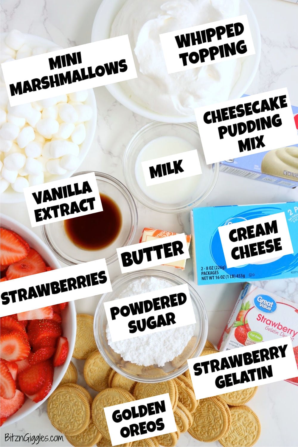 Ingredients arranged on a countertop, including strawberries, cream cheese, marshmallows, Golden Oreos, pudding mix, and whipped topping.