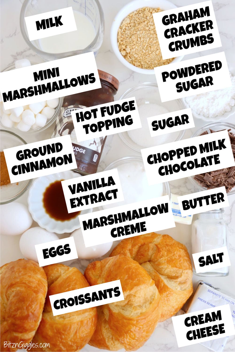 Croissants surrounded by milk, graham cracker crumbs, marshmallows, chocolate, cream cheese, butter, eggs and baking ingredients.