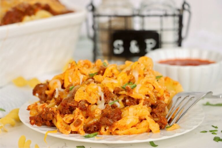 Cheesy ground beef and egg noodles with melted cheese and fresh green garnish.