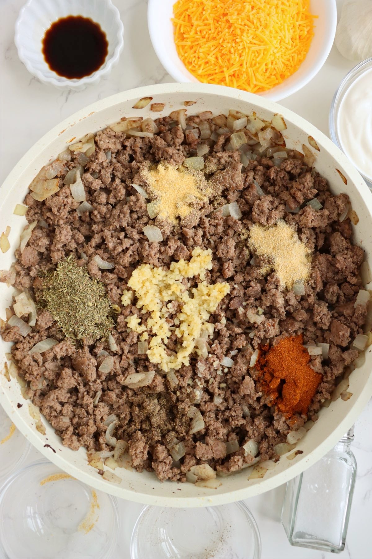 Browned ground beef and tender onions topped with minced garlic, dried seasonings, smoked paprika and garlic powder.