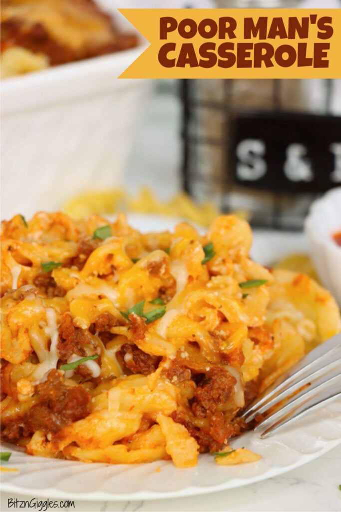 Cheesy egg noodle casserole with seasoned ground beef, tomato sauce, melted cheese and fresh parsley served on a white plate.